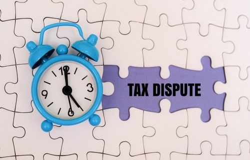When disputing taxes, should you pay first or wait until it is resolved?