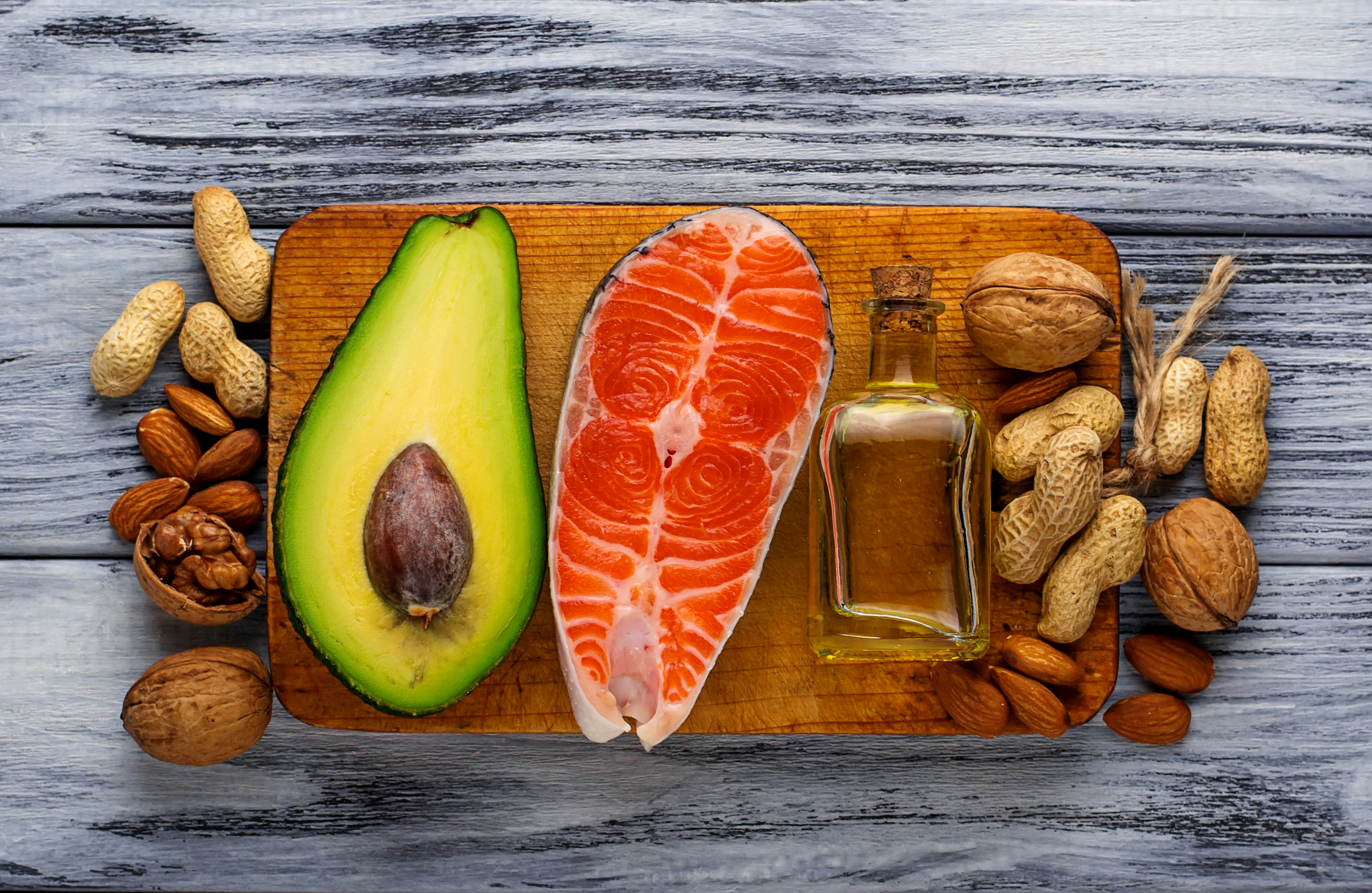 Healthy fat salmon, avocado, oil, nuts. Selective focus