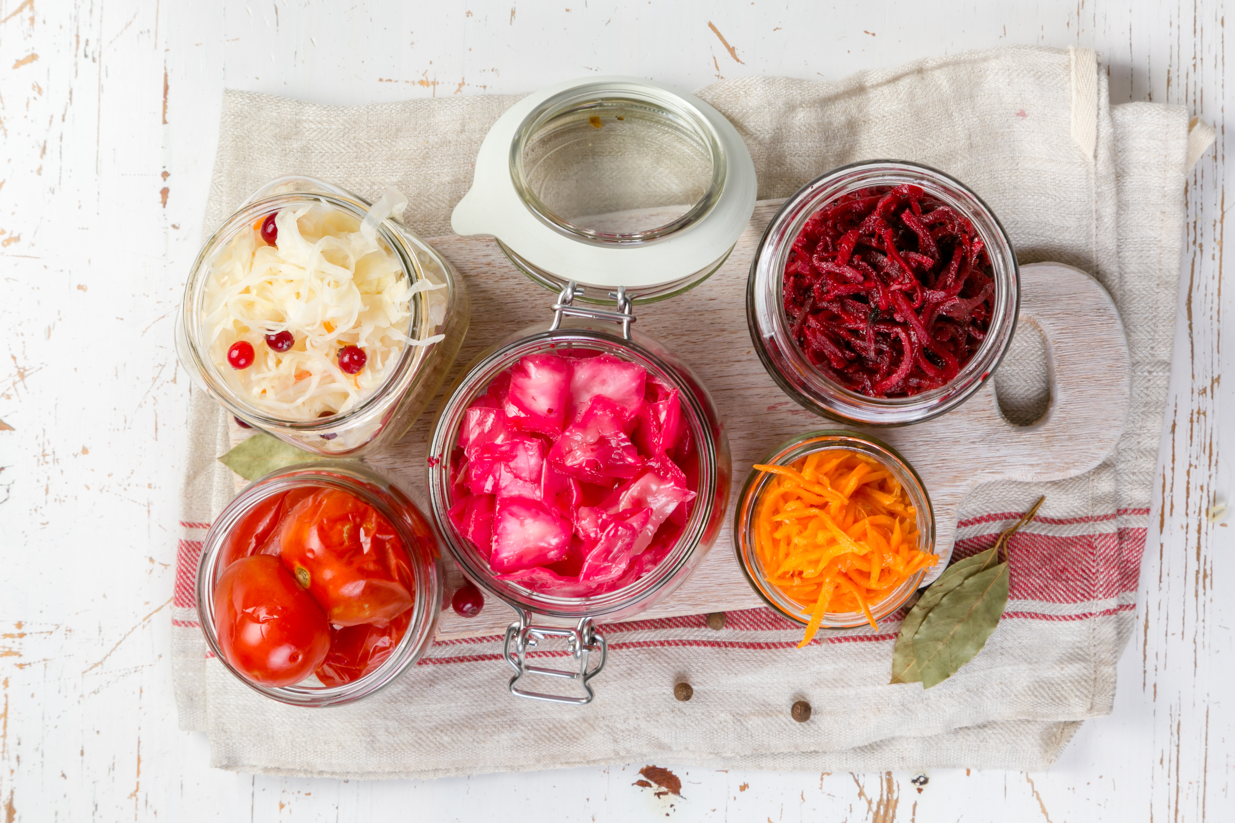 Selection of fermented food - carrot, cabbage, tomatoes, beetroot, copy space wood background