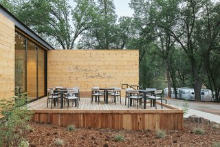 The patio invites dining alfresco under a neon sign custom-created for AutoCamp.