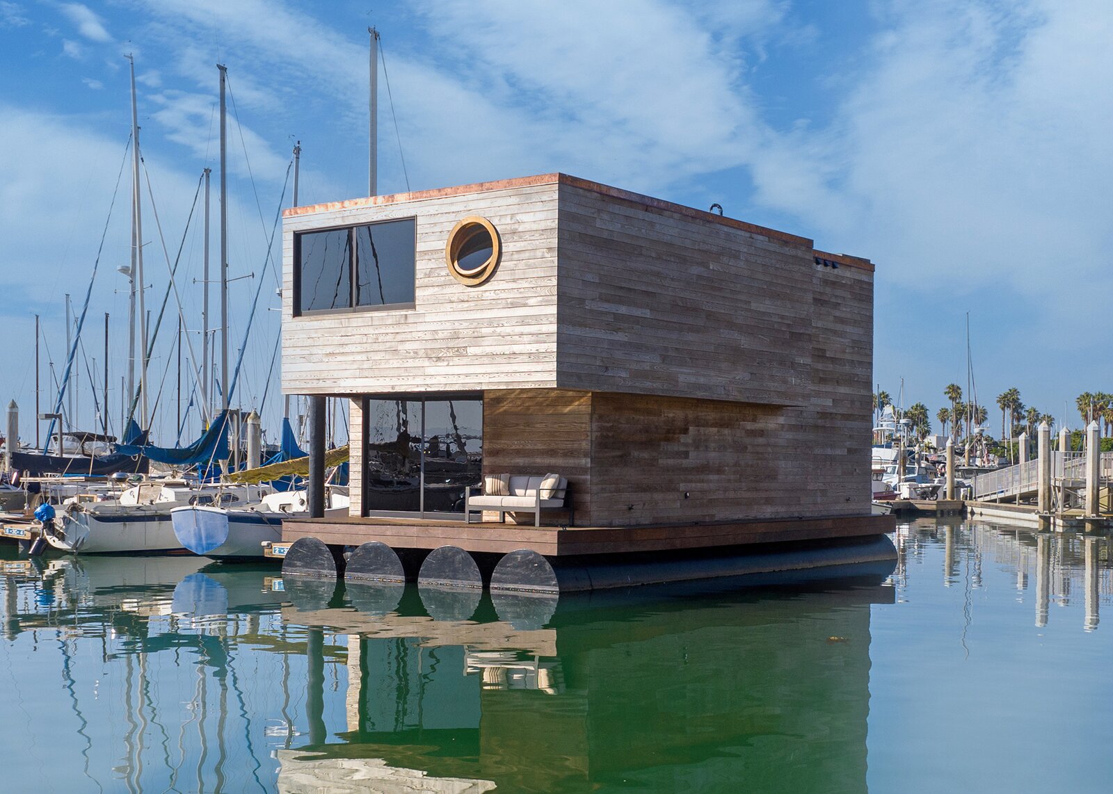 Built by a father and son duo over the course of four years, the two-story nautical dwelling features handcrafted carpentry and a covered deck.
