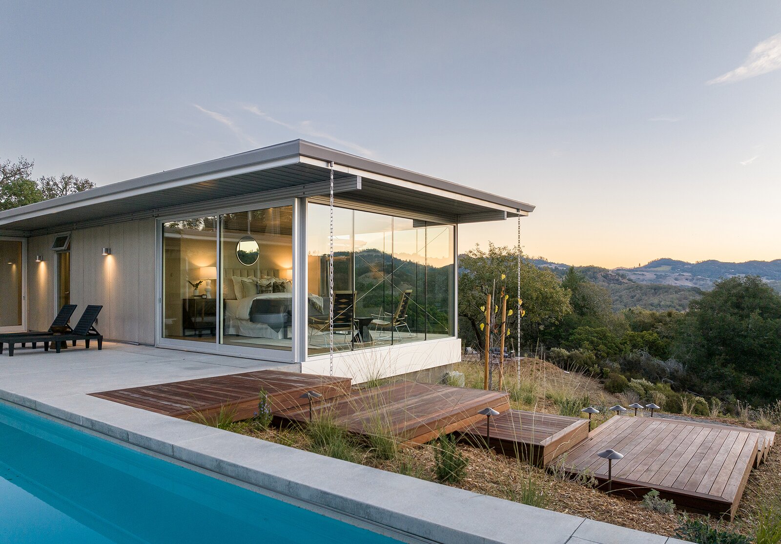 Built using the prefabricated Blue Sky and IT House systems, the residence comes with a guesthouse, a sparkling lap pool, and 10 wooded acres.