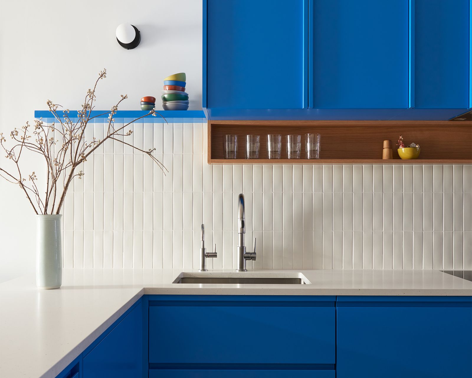 This formerly beige Brooklyn home now relishes in a range of blues, greens, and orangey-reds, with terrazzo and tile to spare.