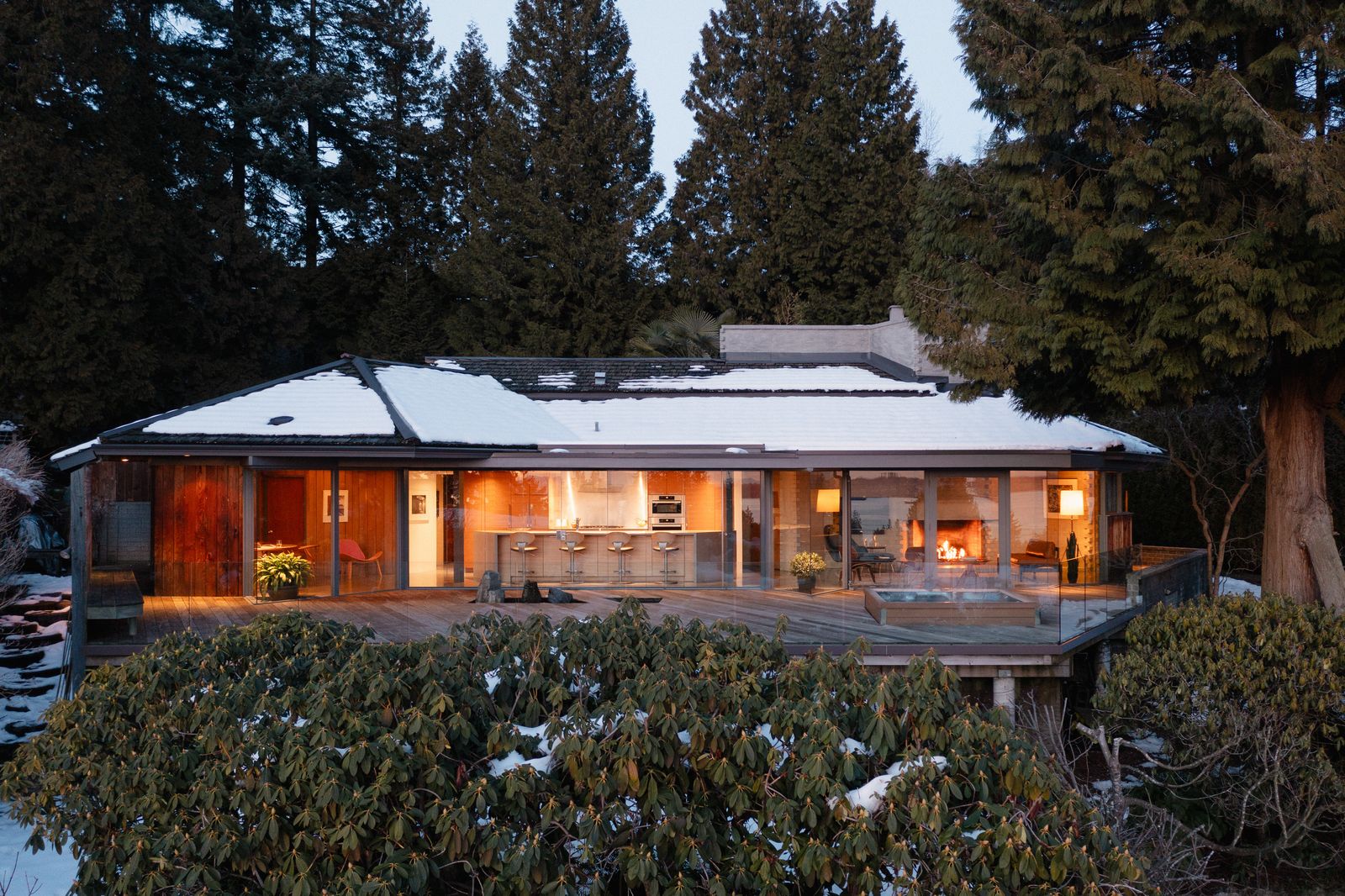The midcentury home has an unusual geometric plan, a suite of built-in furniture, and a monolithic concrete fireplace.
