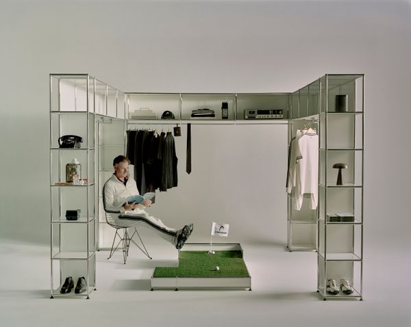The unit is made from USM’s Haller modular shelving system. It features an arrangement of cubbies and clothing racks.