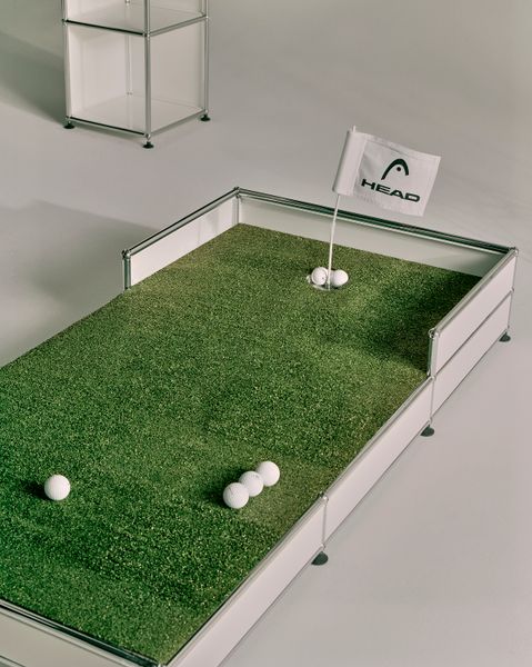 The putting green matches the shelving in a white colorway.