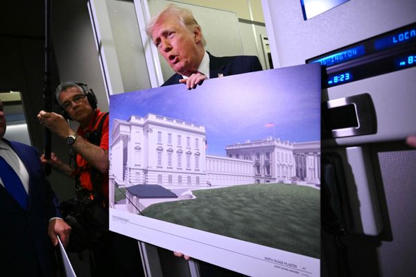 Trump shares a plan of the new East Wing plan with reporters aboard Air Force One in March of 2026.