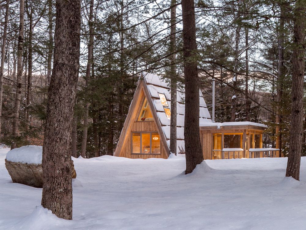 An artist and an engineer built this tiny A-frame cabin with local materials, custom built-ins, and lots of windows.