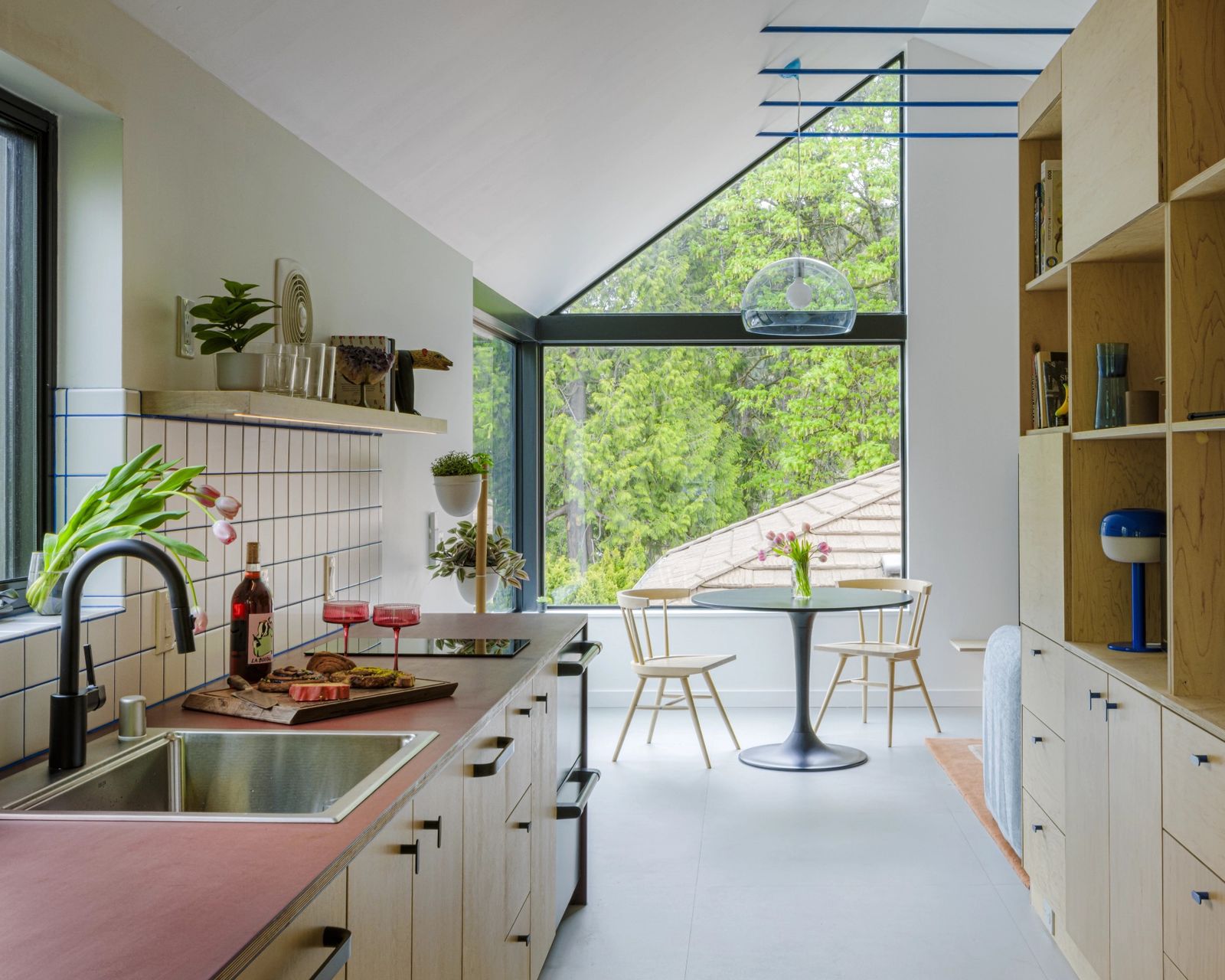 Best Practice Architecture retooled this Seattle garage into a colorful ADU with a bed nook, storage to spare, and windows for the resident dog and its owners.