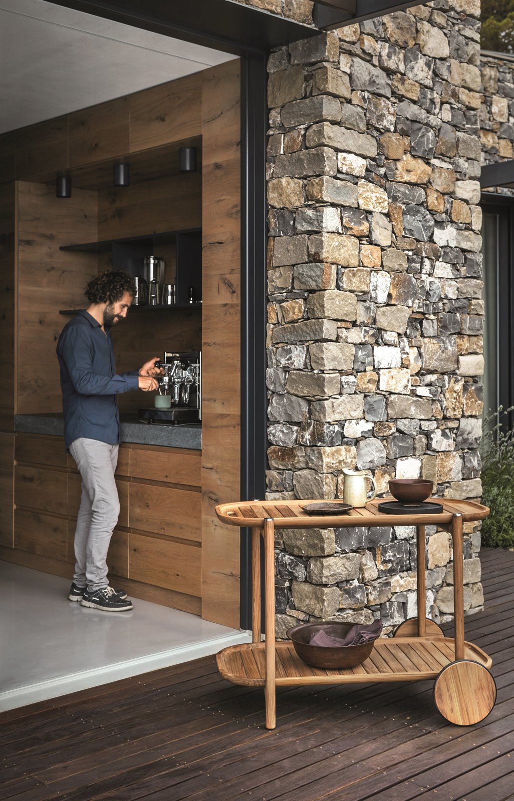 Pedersen's design for the new Bar Cart seamlessly blends aesthetics with functionality. The cart’s integrated handle and large wheels facilitate smooth passage on uneven ground while twin trays offer ample space for serving. The generous gaps between the slats make for easy cleanup.