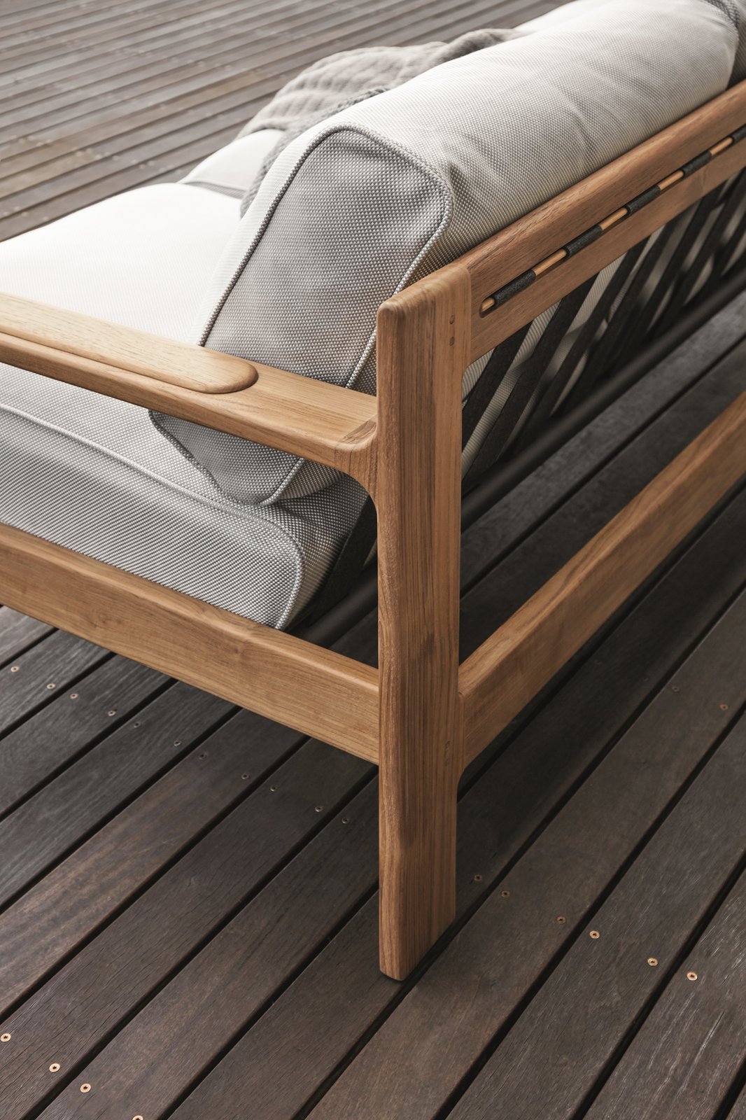 Comfortable cushions are supported by teak frames and partially elasticated outdoor webbing straps. Thoughtful design details, like subtle curves, add a level of sophistication that the company is known for.