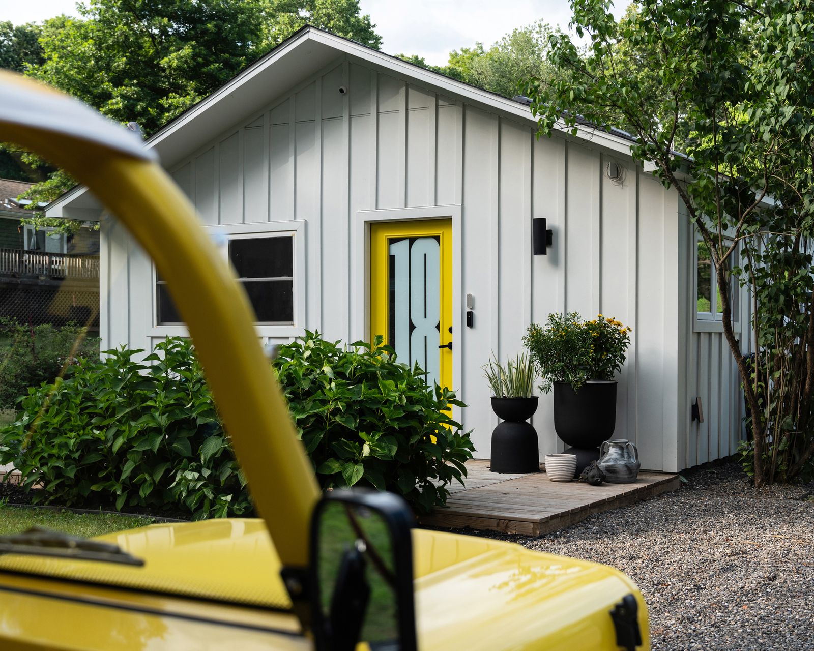 With a brand-new plan, vibrant decor, and a bright-yellow door, Ghislaine Viñas reinvigorated a 600-square-foot kit house for her family.