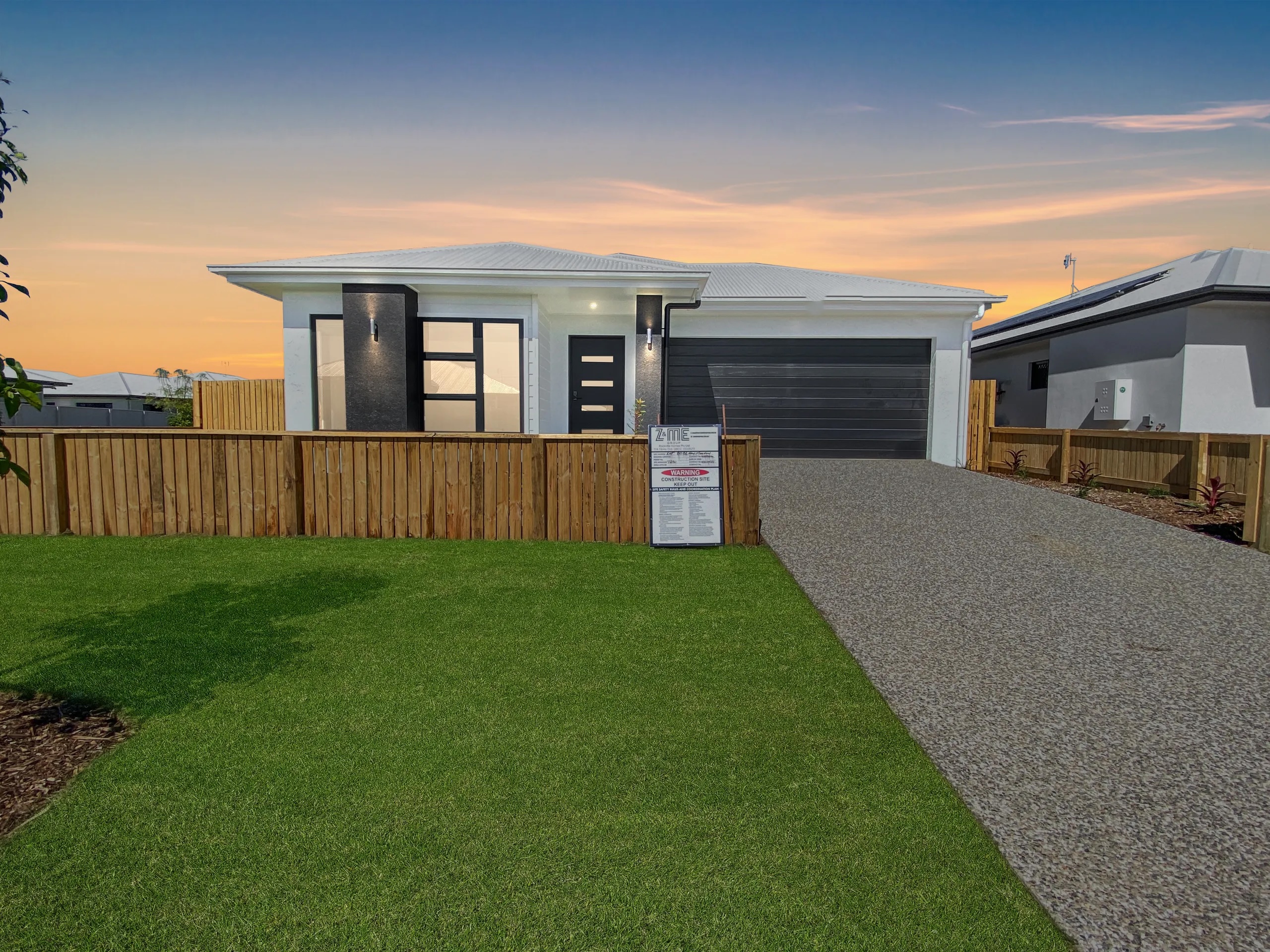 Front of 7 New Meadow Circuit, Shaw, at dusk with the double garage and driveway