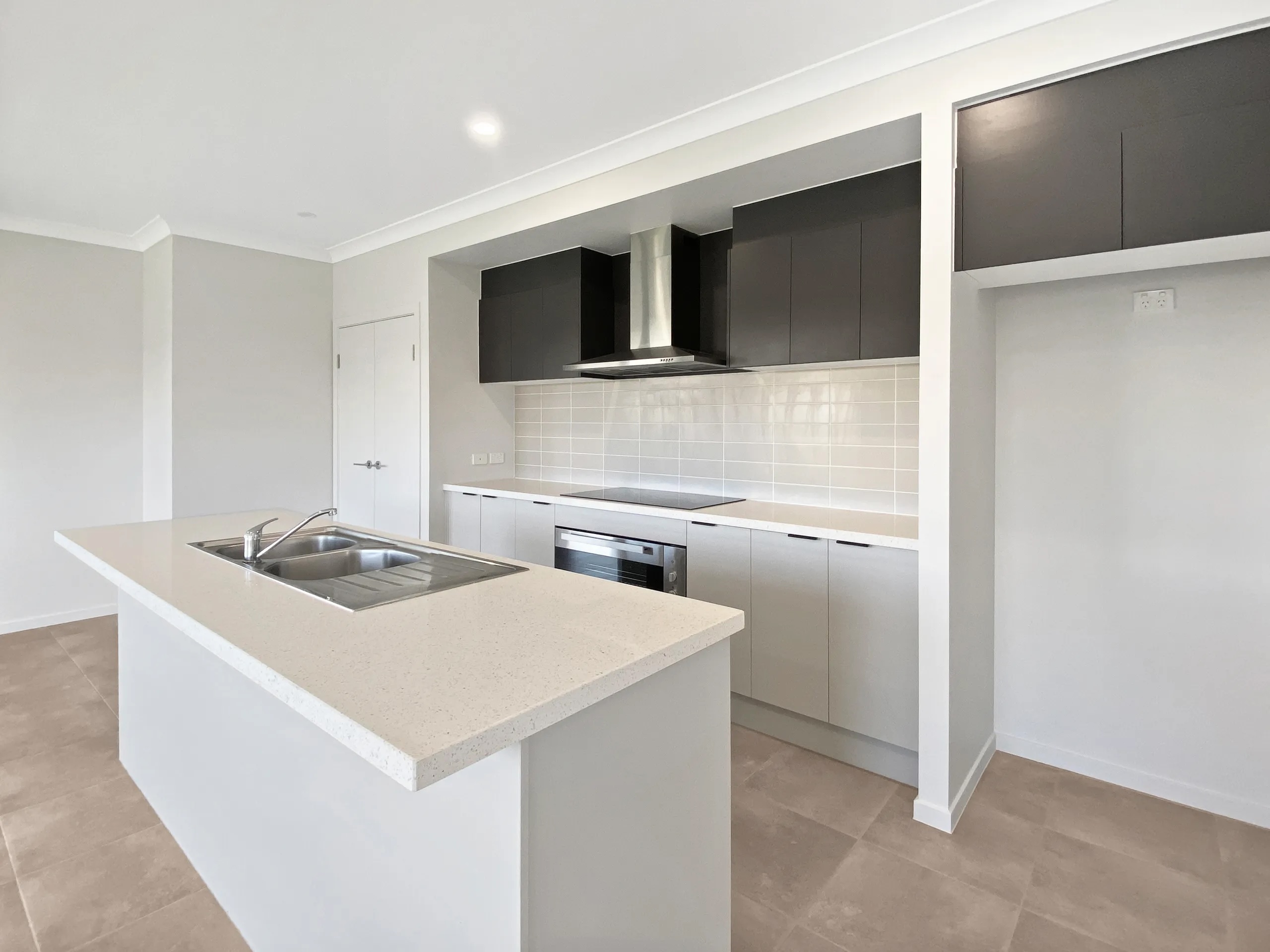 Kitchen with island bench and stainless appliances