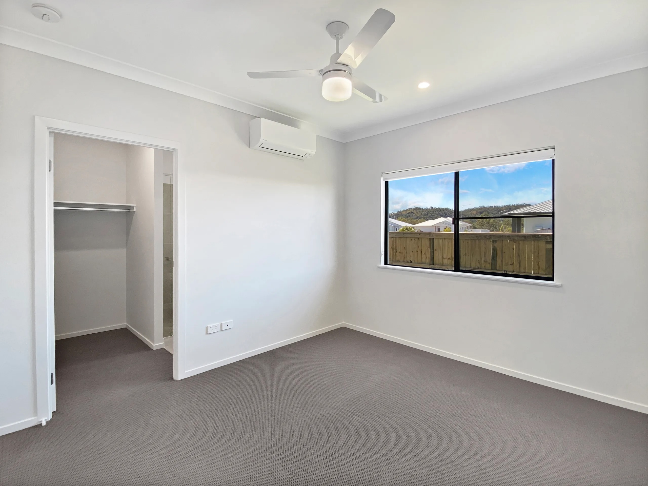Carpeted bedroom with robe and air conditioning