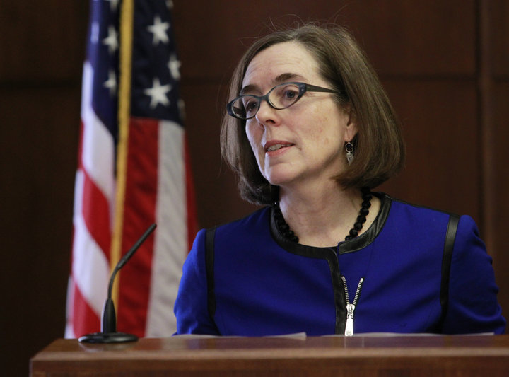 Oregon Governor Kate Brown speaking at a podium. But in the event of such intervention, Oregon legislators hope to protect the personal information of marijuana consumers.