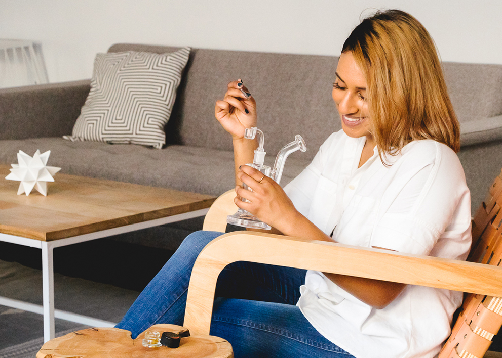 sitting girl dabbing marijuana concentrate