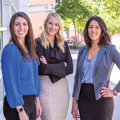 A group of professional women smiling at the camera