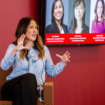 A woman presenting and explaining an in depth concept