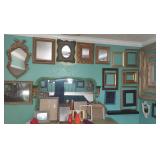 Room full of many artwork , picture frames & mirrors 