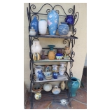 Bakers rack full of unique pottery