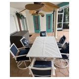 Outdoor dining table with 6 swivel rocking chairs with cushions