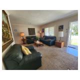 Green leather sleeper sofa with coordinating loveseat and oversized chair