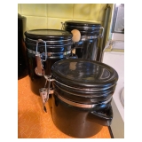 Set of 3 Black Stoneware Canister Set w Clamp Lids. $30