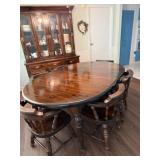 Dark wood dining room set, including round table with leaf to make oval six chairs