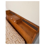 Headboard of bed has pullout drawer. Some damage on lower left headboard