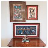 Egyptian art and figurines atop vintage dresser