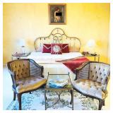 Master Queen bedroom with original artwork and vintage cane chairs, rug, side tables and clothing