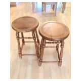 Two low carved wood bar stools