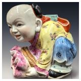 A Large Chinese Famille Rose Child Sculpture With A Six Character Mark