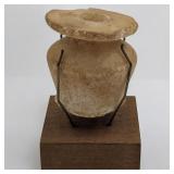 A Small Egyptian Alabaster Perfume Jar With Wooden Stand