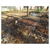 WROUGHT IRON TABLE WITH STAR AND 2 CHAIRS VERY THICK AND HEAVY. TABLE MEASURES 29" X 25"