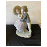Lladro - precocious love boy kissing girl
