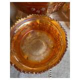 Fenton marigold carnival glass bowl in the Butterfly and Berry pattern with a sawtooth edge