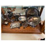 silver-plated serving dishes and tea set items. 