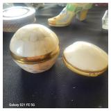 a small spherical box in bronze covered with mother-of-pearl. 
