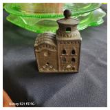 an antique cast iron still bank, commonly known as a "Domed Mosque" or "3-Story Mosque" bank.  It wa