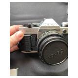 a vintage Canon AE-1 35mm SLR film camera with a flash attachment and a "Popular Filter" accessory b