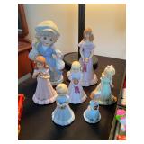 vintage KPM porcelain figurines of a girl with a goose and a collection of Enesco "Growing Up Birthd