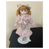  porcelain doll appears to be from the Heritage Mint Collection. 