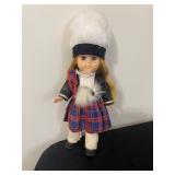 vintage Vogue Ginny doll.  Wears a traditional Scottish outfit including a red plaid kilt, a black j