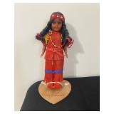 vintage Native American souvenir doll, specifically identified as being "MADE BY The Cherokees" on i