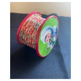  a squeeze box this small, handheld toy features an accordion-style design with pleated paper or fab