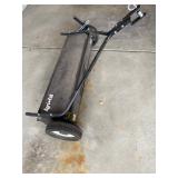 an Agri-Fab tow-behind lawn sweeper. 