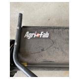 an Agri-Fab tow-behind lawn sweeper. 