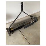 an Agri-Fab tow-behind lawn sweeper. 